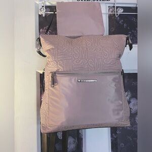 Steve Madden light pink logo backpack with matching wristlet.